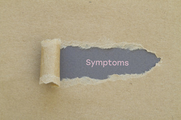Symptoms word written under torn paper.