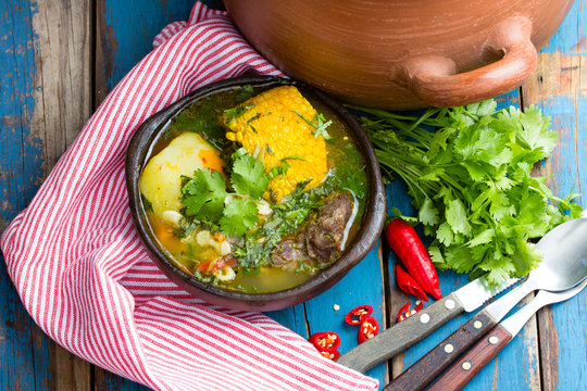 Latin american food. Cazuela - traditional chilean soup served in clay plate from pomaire