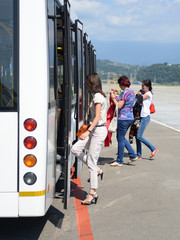 Passengers board a bus