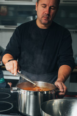 Man cooking in a metal pan