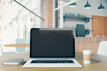 Blank laptop, coffee and notebook