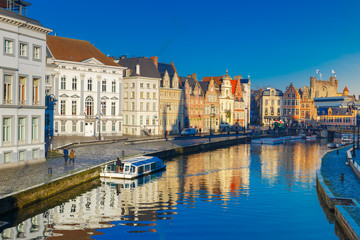 Obraz premium Picturesque medieval buildings on quay Korenlei and quay Graslei, Leie river in the morning, blue hour, Ghent, Belgium