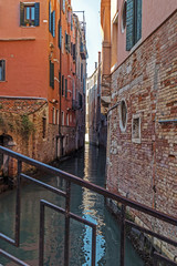 Canal between old buildings in Venice, Italy 1