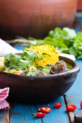 Latin american food. Cazuela - traditional chilean soup served in clay plate from pomaire
