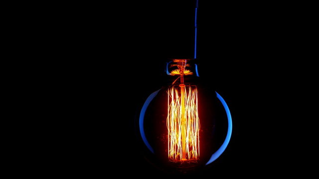 Vintage filament Edison light bulb. Close up. 4K UHD video.
