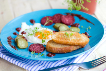 Eggs with sausages and toasts for breakfast