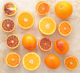 oranges whole and cut in half on a marble background. background