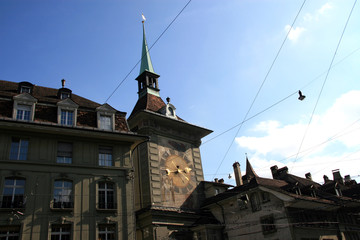 Fototapeta na wymiar City clock / Buildings, city clock on the house roof in the old town of Bern