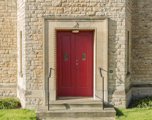 Fototapeta na wymiar Red door with crest above