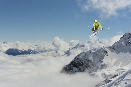 Flying skier on mountains. Extreme sport.