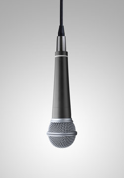 upside down microphone on gray background