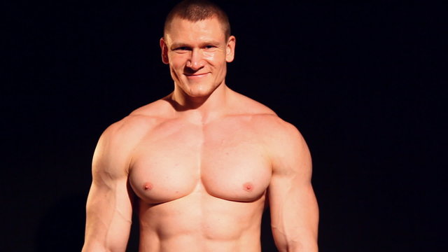 bodybuilder shows off his muscles