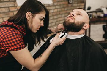 Bearded hipster client visiting barber shop 