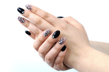 Beautiful hands with black and gray manicure of artificial nails with the gel