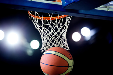 Basketball going through the hoop at a sports arena (intentional