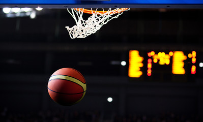 Basketball going through the hoop at a sports arena (intentional