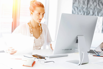 Attractive office worker sitting at desk