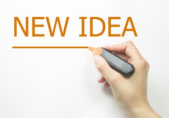 Hand writing new idea with green marker on transparent wipe board