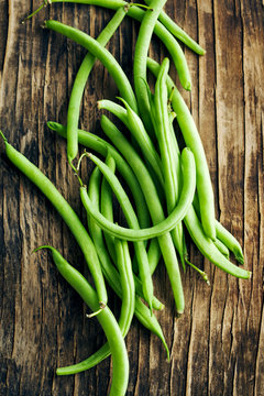 Fresh green beans on wooden background