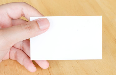 Obraz premium Blank name card in hand background