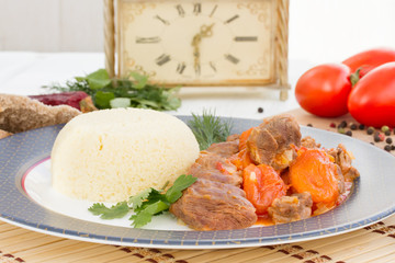 Lamb stew in Arabic with vegetables and dried apricots.