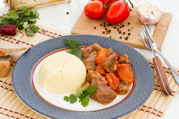 Lamb stew in Arabic with vegetables and dried apricots.