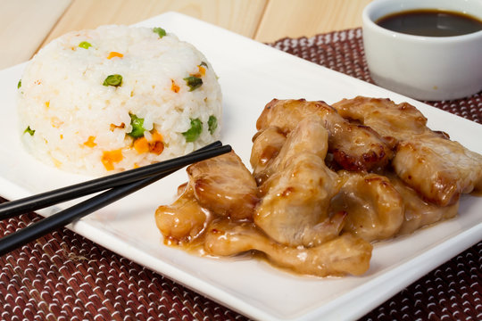 Pork in sweet and sour sauce and rice with vegetables