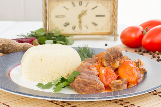 Lamb stew in Arabic with vegetables and dried apricots.