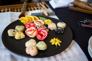 Korean sweets on a black plate, tea ceremony table, selective focus