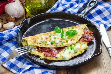 Bacon stuffed omelette on a iron cast pan