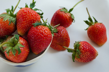 Fresh Strawberries In Bowl On White Fabric Background.