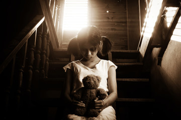 Ghost girl in haunted house holding teddy bear - 105808319