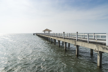 Fototapeta na wymiar The wooden bridge walkway into the sea.