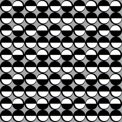 Geometric pattern with black and white circles on grey background