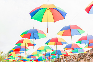 Fototapeta na wymiar Rainbow umbrella on sky background