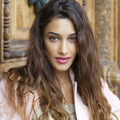 Naklejka premium Beautiful young woman in pink coat