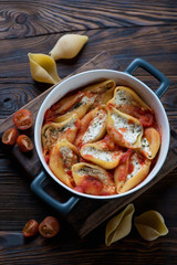 Conchiglioni with cottage cheese in a baking dish, above view