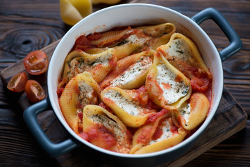Conchiglione baked with cottage cheese and tomato sauce, closeup