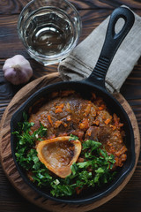 Above view of a frying pan with freshly cooked osso buco