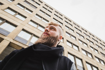 Stylish bearded man posing in the street