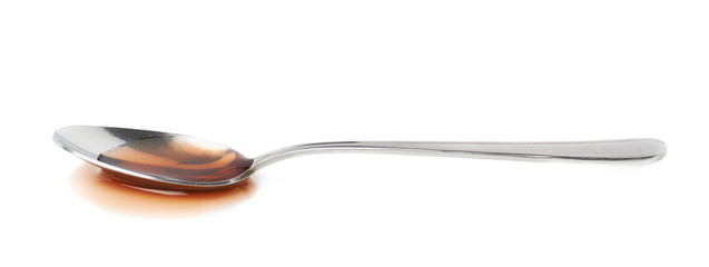 Steel spoon in a puddle of wine vinegar