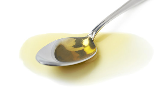 Steel Spoon In A Puddle Of Olive Oil