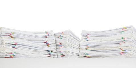 Overload of paperwork with colorful paperclip isolated on white background