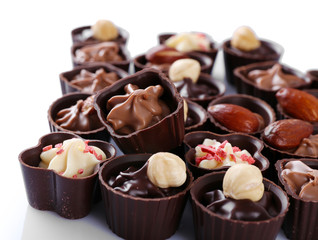 Delicious chocolate candies on white background