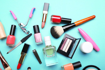 Decorative makeup cosmetics and manicure tools on turquoise background