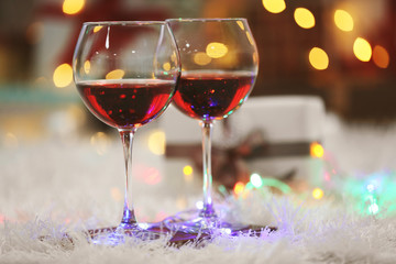 Two glasses of red wine on Christmas decoration background