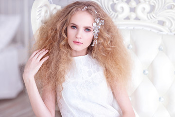 Young gorgeous woman, bride, blond long curly hair