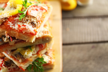Pieces of delicious pizza on the table, close-up