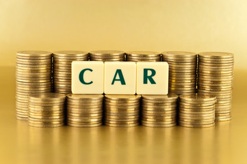 The letters  CAR with stacks of coins