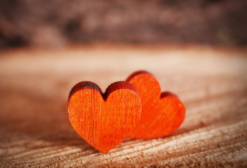 Valentine concept. Two love hearts on wooden background